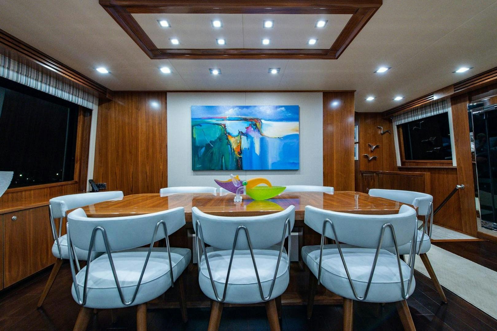 a room with tables and chairs aboard OBSESSION Yacht for Sale