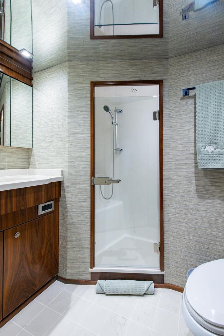 a bathroom with a shower unit and a toilet aboard OBSESSION Yacht for Sale