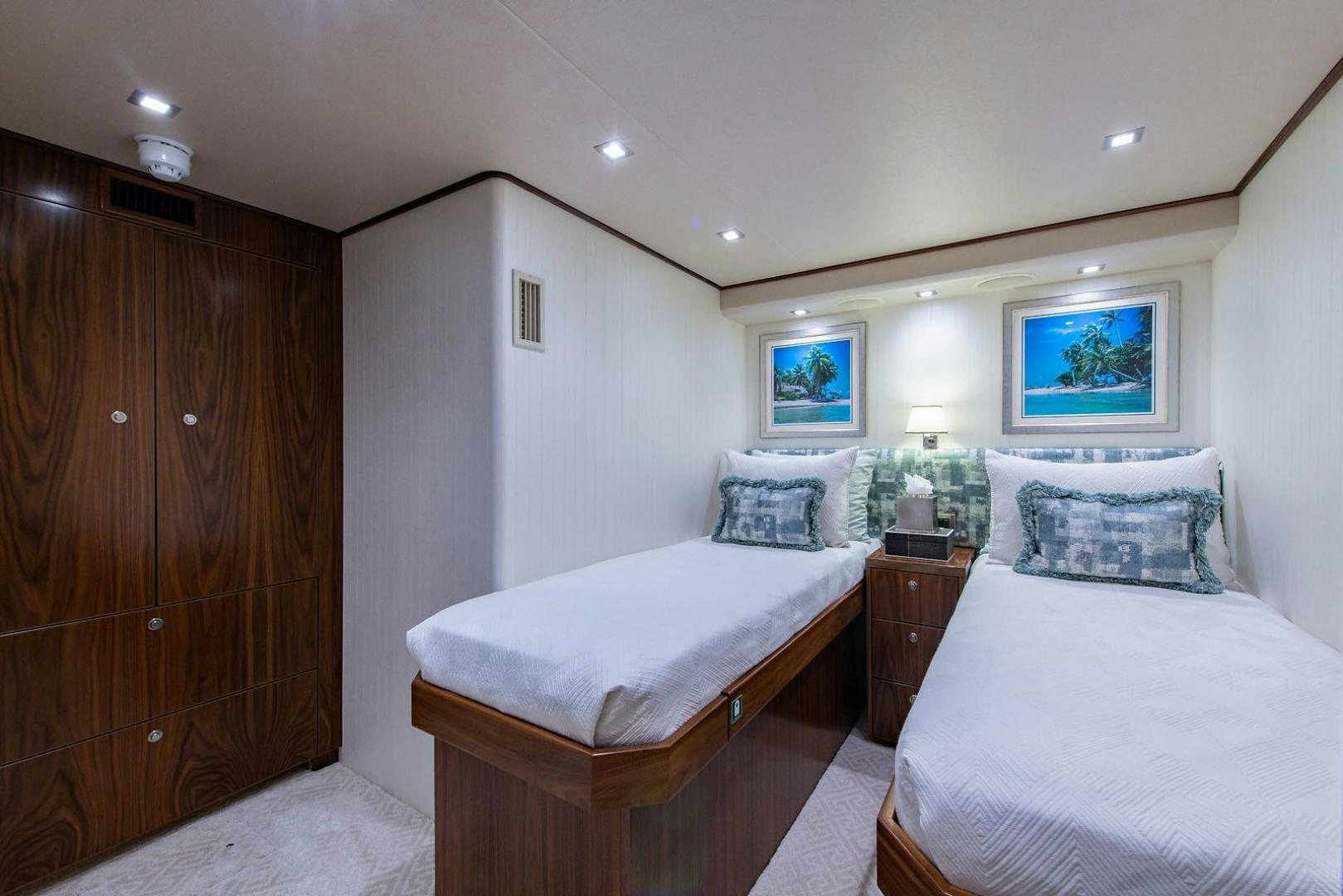 a couple of beds in a room aboard OBSESSION Yacht for Sale