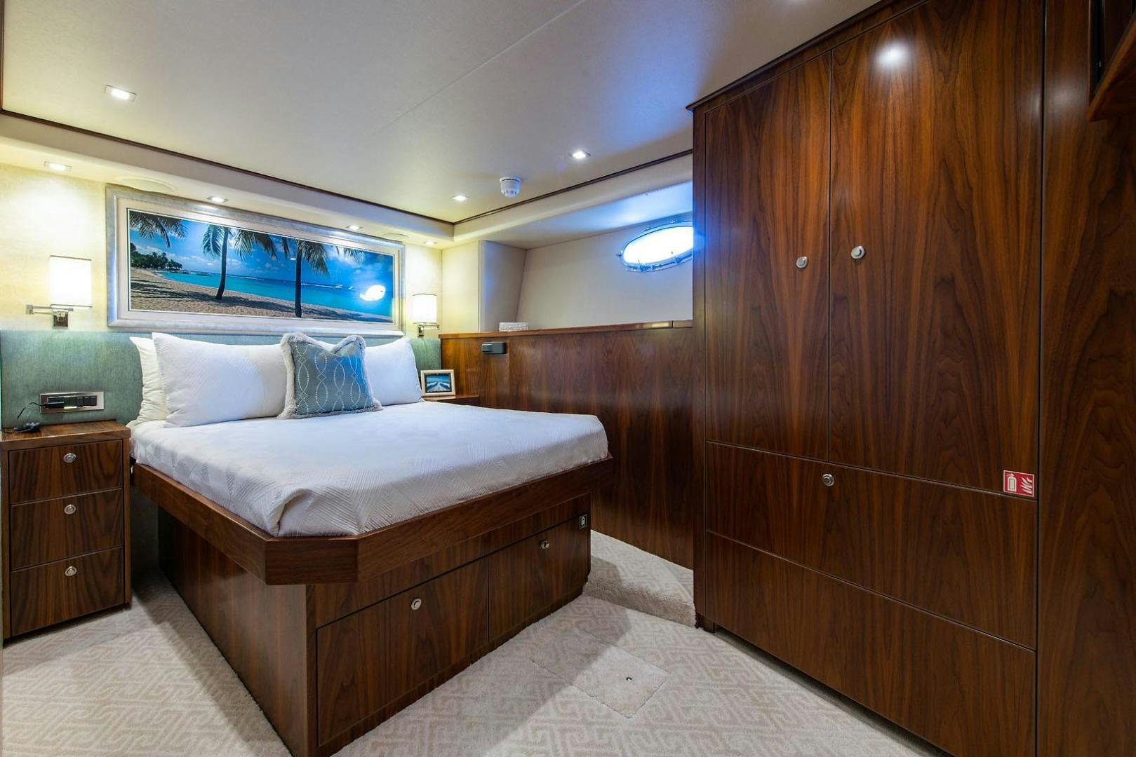 a bedroom with a bed and a wood wall aboard OBSESSION Yacht for Sale