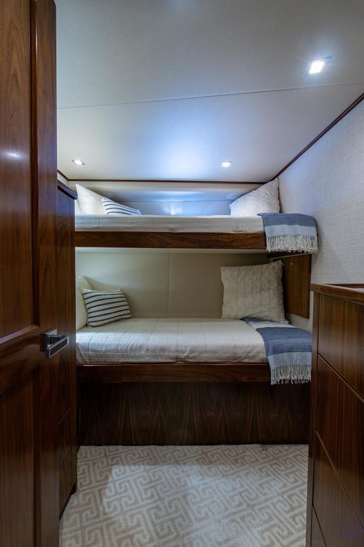a bed with a wooden frame aboard OBSESSION Yacht for Sale