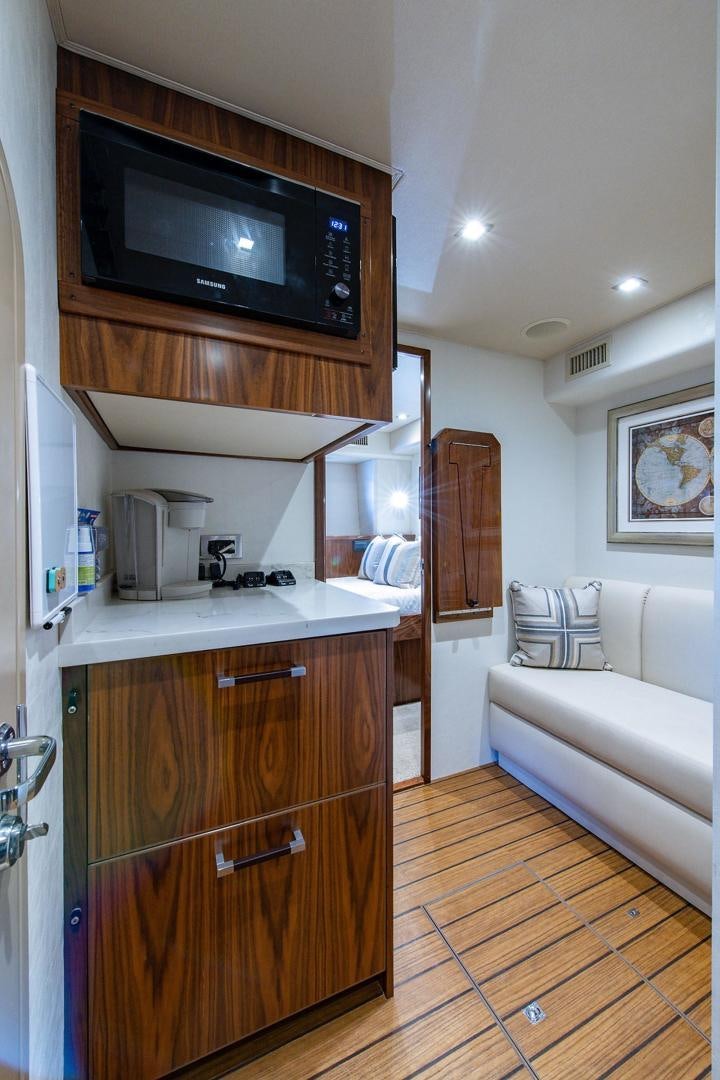 a living room with a tv and a couch aboard OBSESSION Yacht for Sale