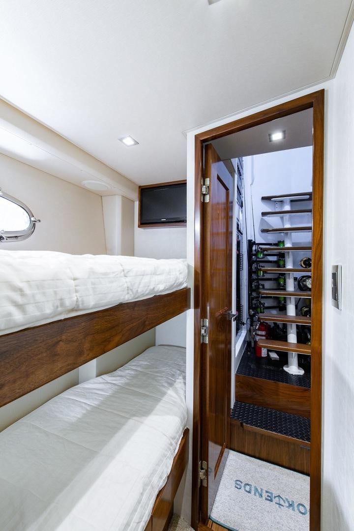 a bedroom with a closet and a bed aboard OBSESSION Yacht for Sale