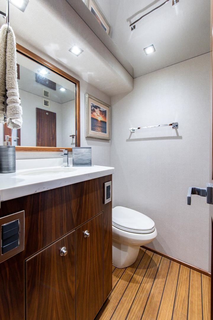 a bathroom with a sink and a toilet aboard OBSESSION Yacht for Sale