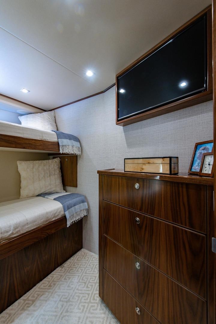 a bedroom with a bed and a tv aboard OBSESSION Yacht for Sale