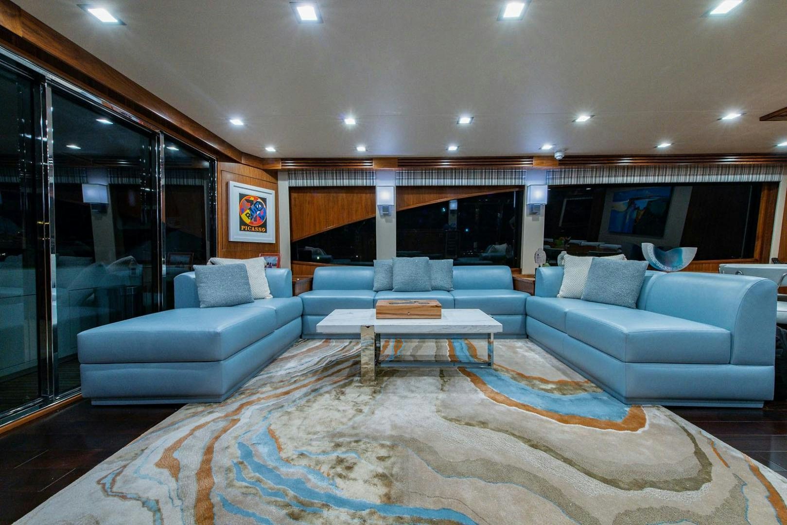 a living room with a large glass door aboard OBSESSION Yacht for Sale