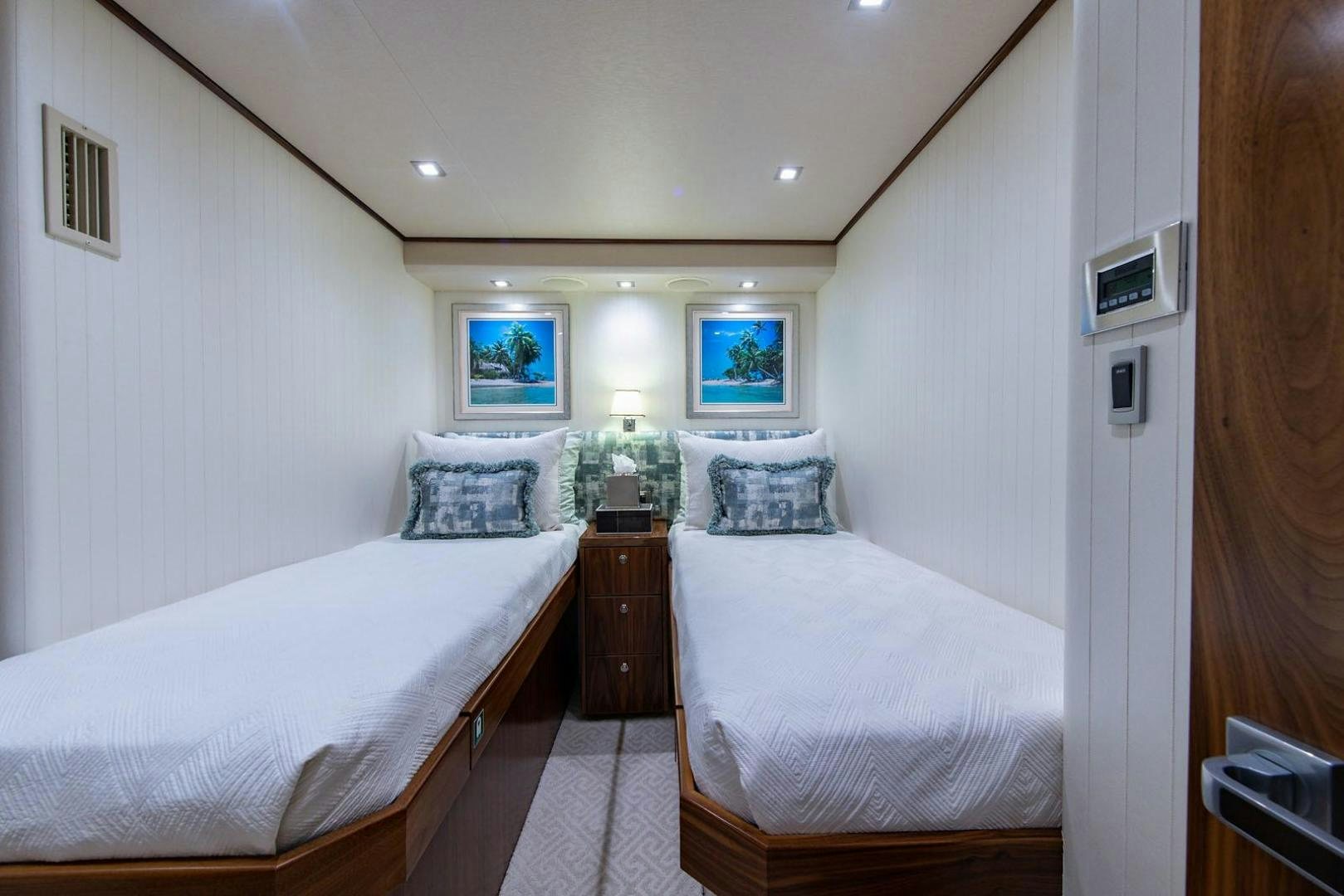 a couple of beds in a room aboard OBSESSION Yacht for Sale