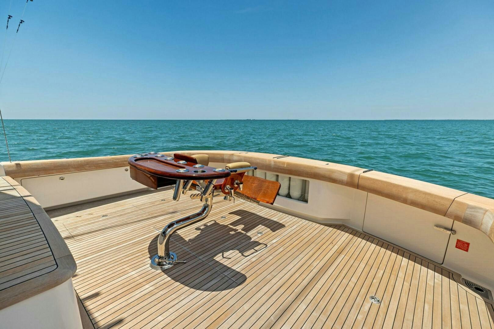 a deck with a table and chairs on it by the water aboard THE PROVIDER Yacht for Sale