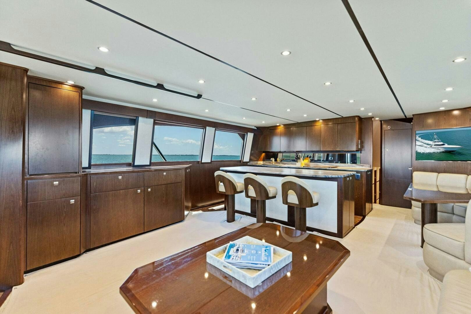 a large kitchen with a bar and a table aboard THE PROVIDER Yacht for Sale