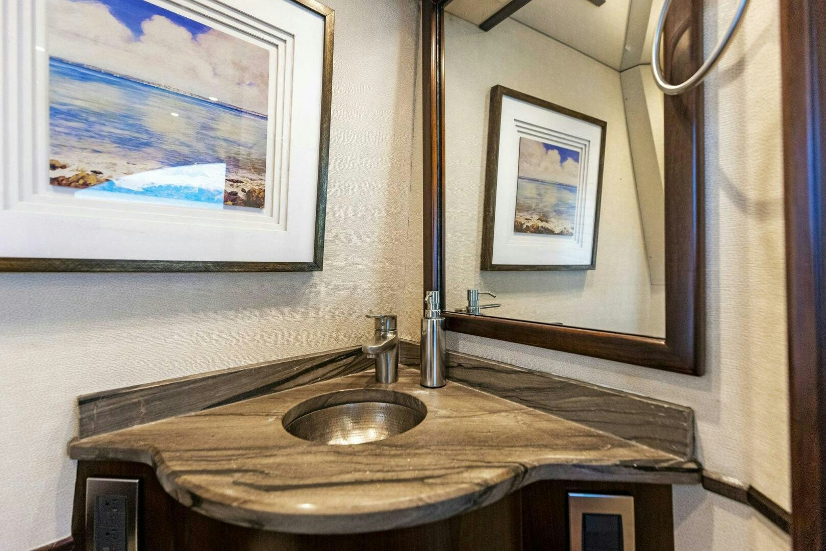 a bathroom with a sink and a painting on the wall aboard THE PROVIDER Yacht for Sale