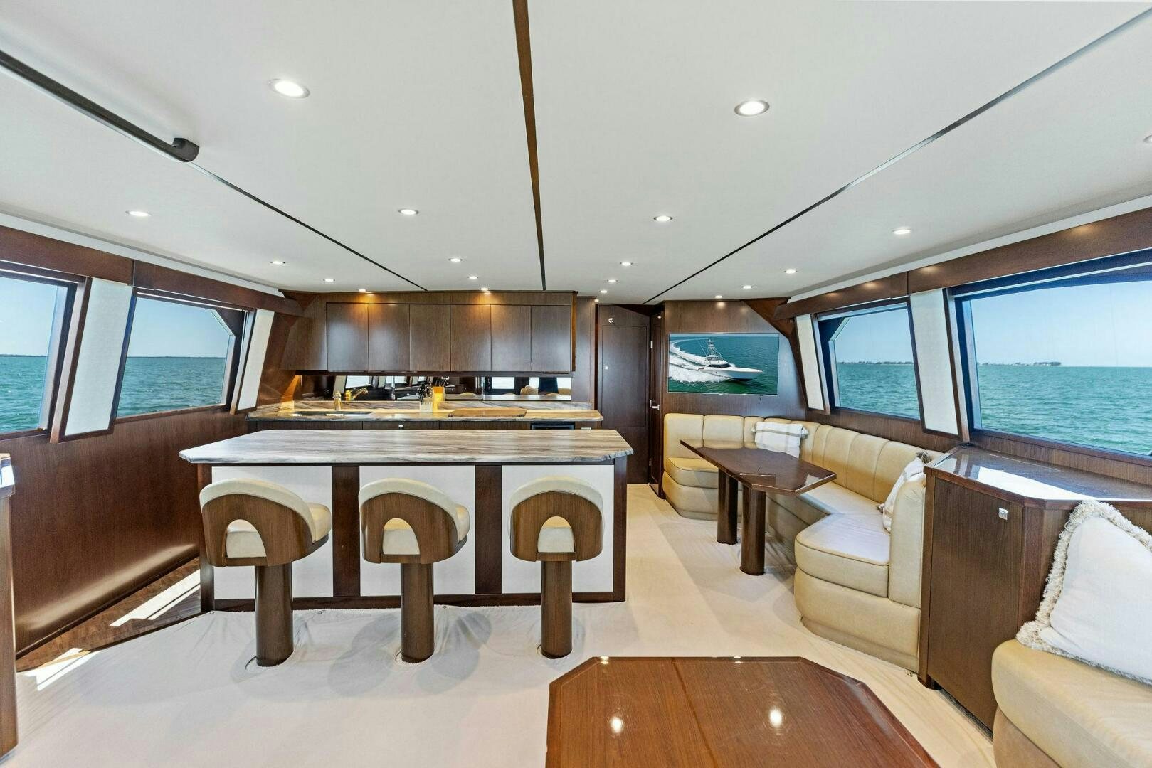 a large living room with a table and chairs aboard THE PROVIDER Yacht for Sale