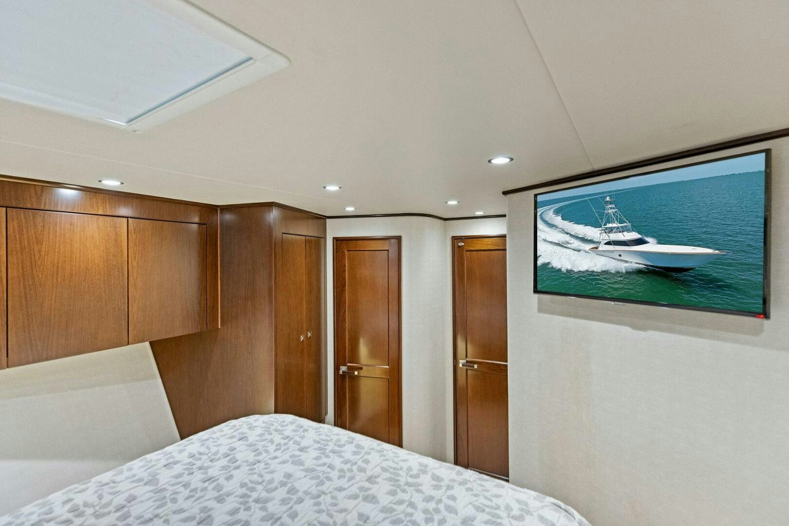 a bedroom with a television and a bed aboard THE PROVIDER Yacht for Sale