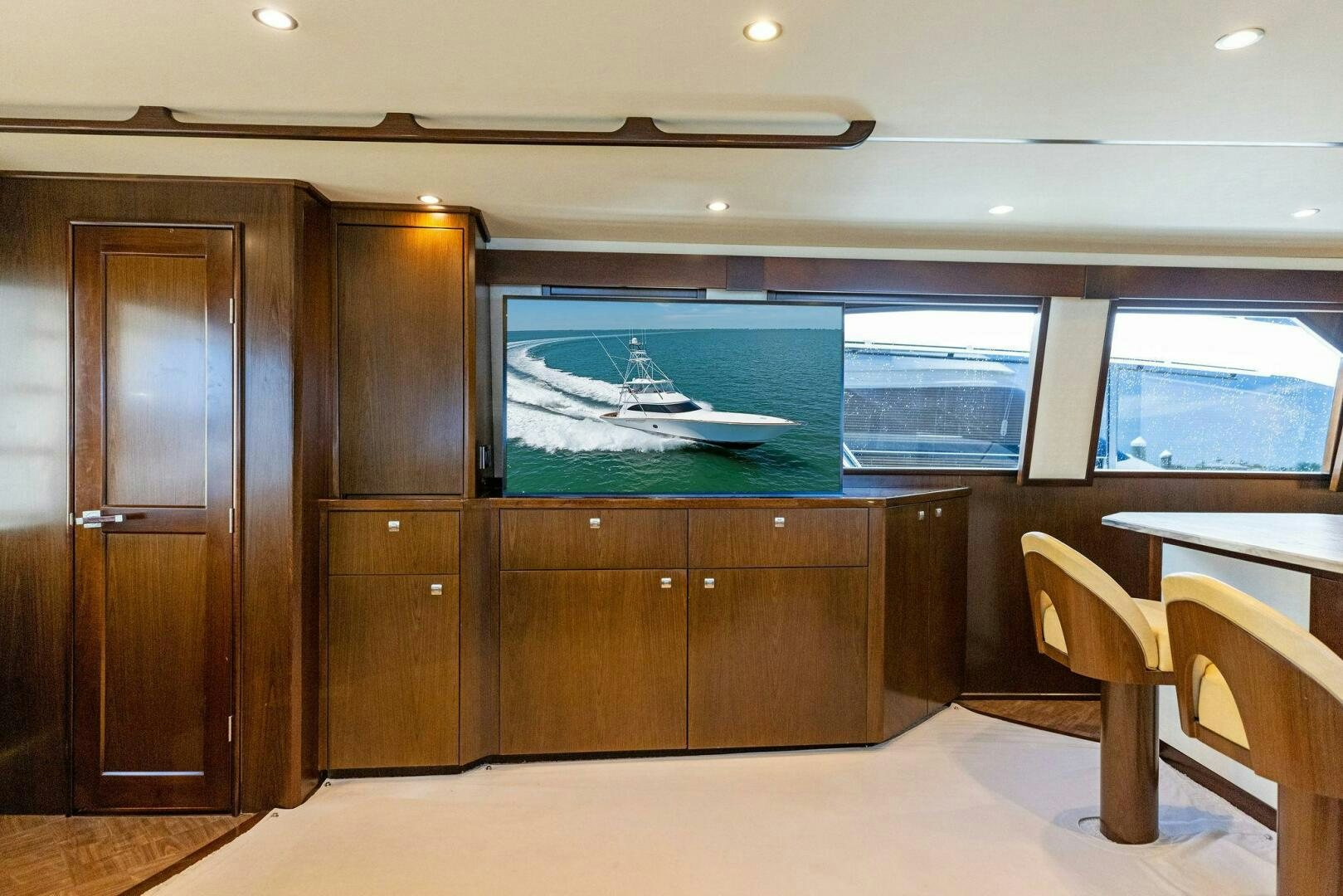a room with a large window and a table and chairs aboard THE PROVIDER Yacht for Sale