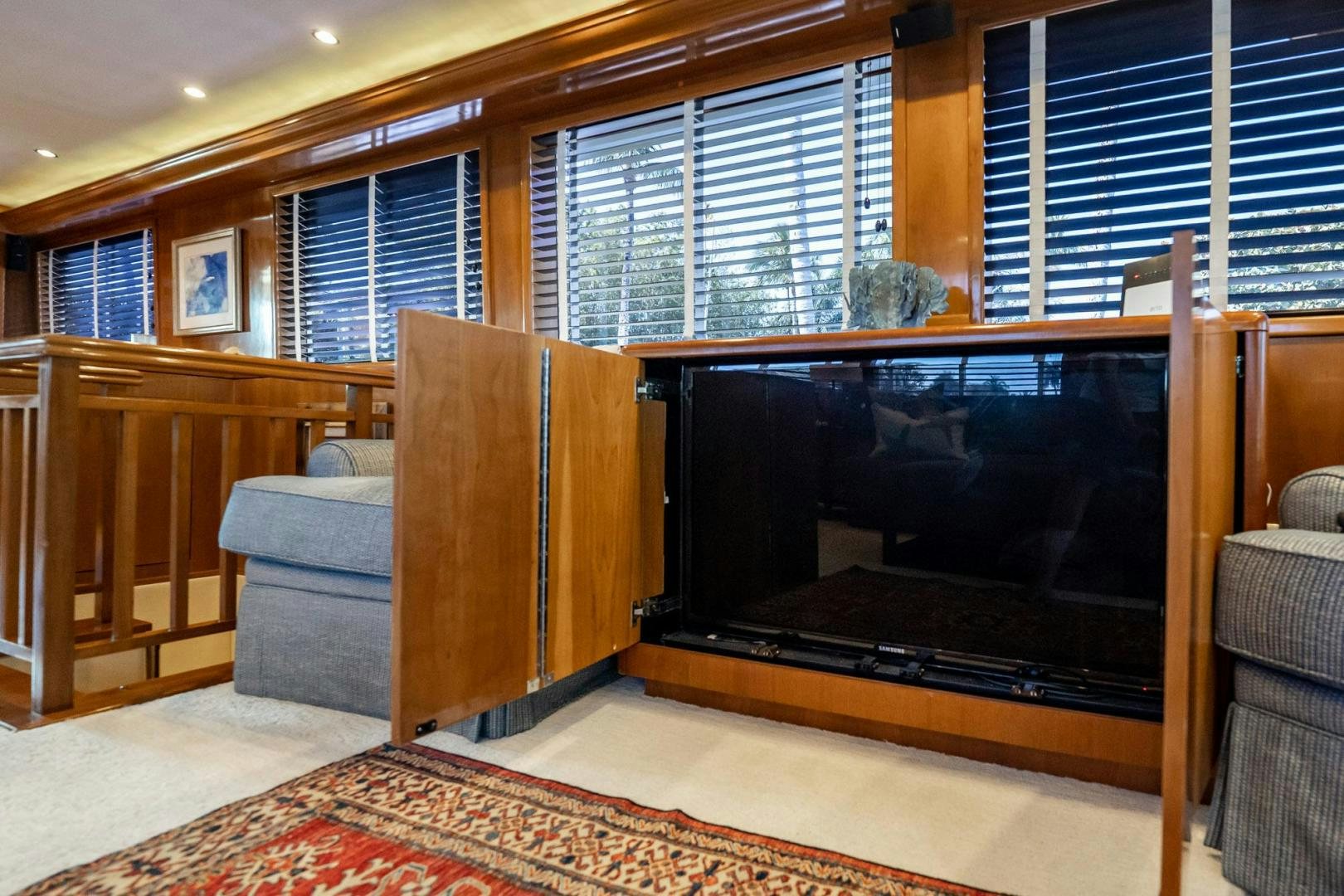 a living room with a tv aboard CRISTINA Yacht for Sale