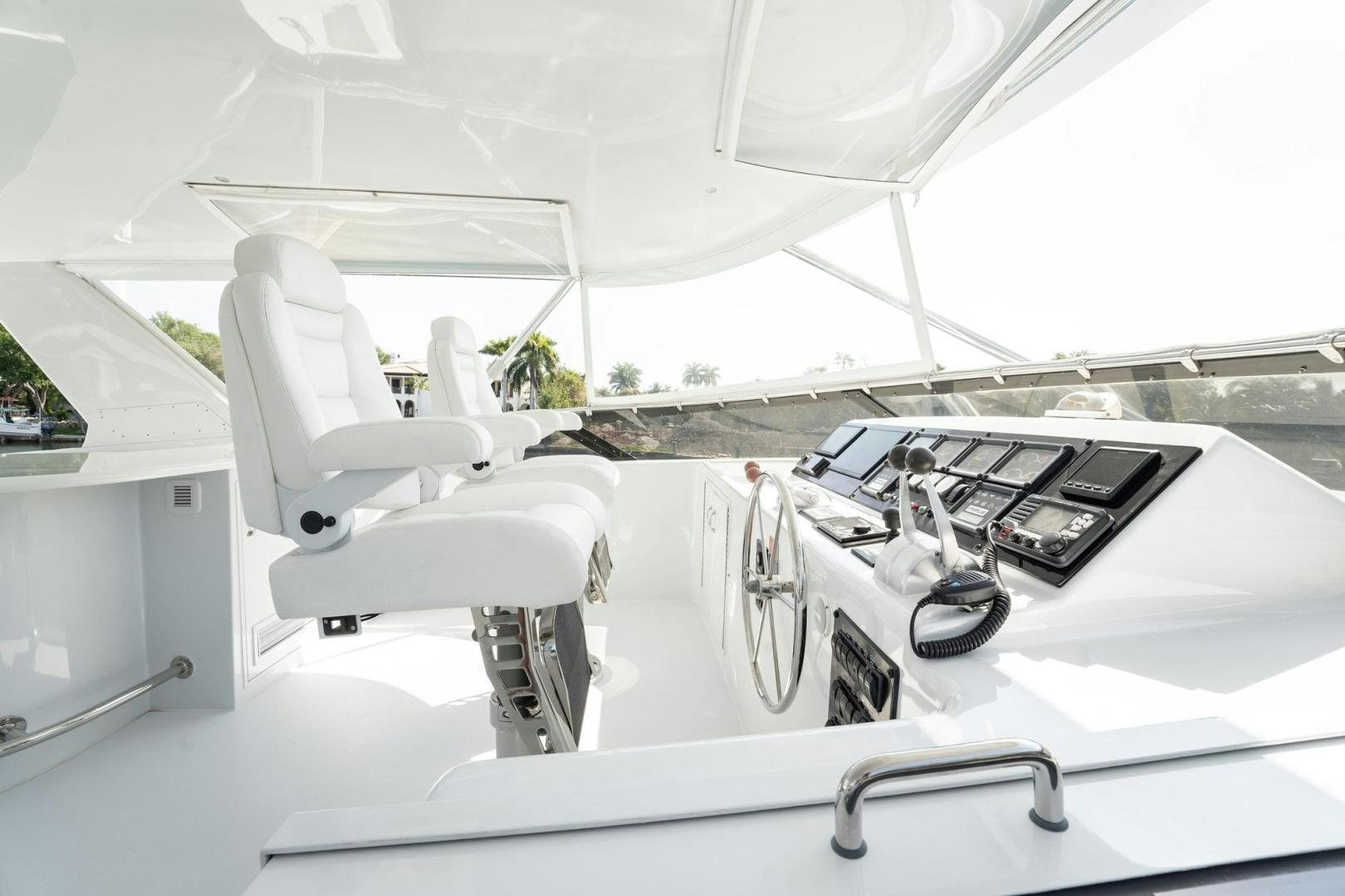 a white chair next to a table aboard CRISTINA Yacht for Sale