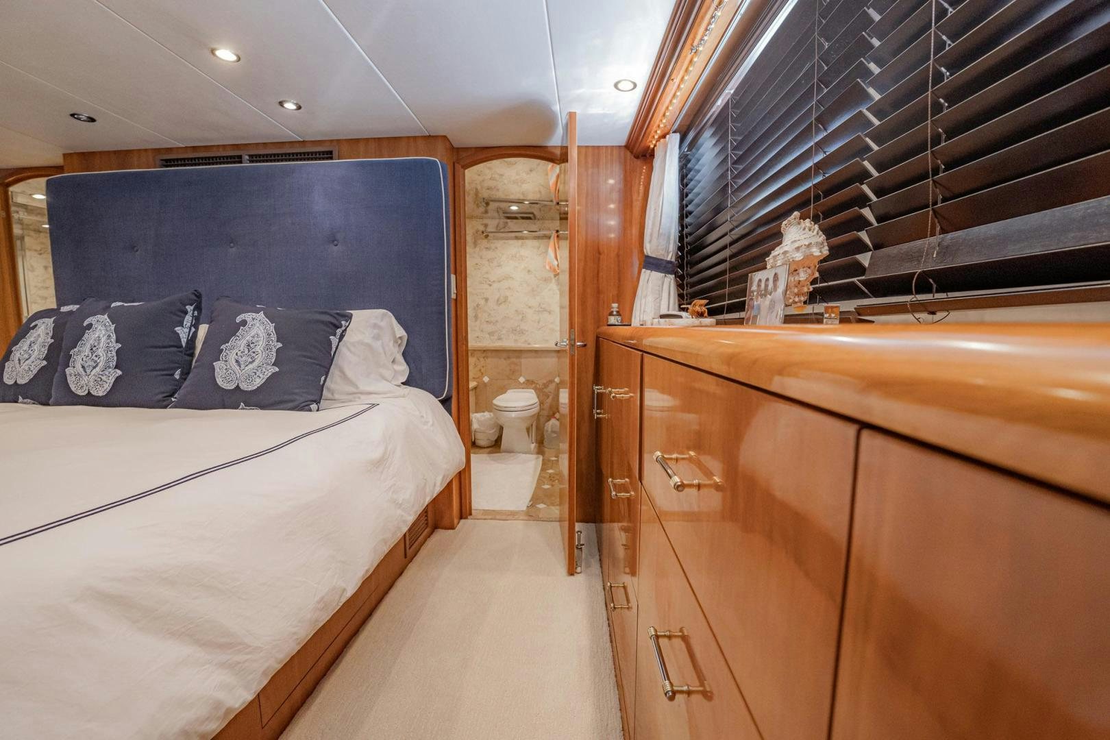 a room with a bed and a wood cabinet aboard CRISTINA Yacht for Sale