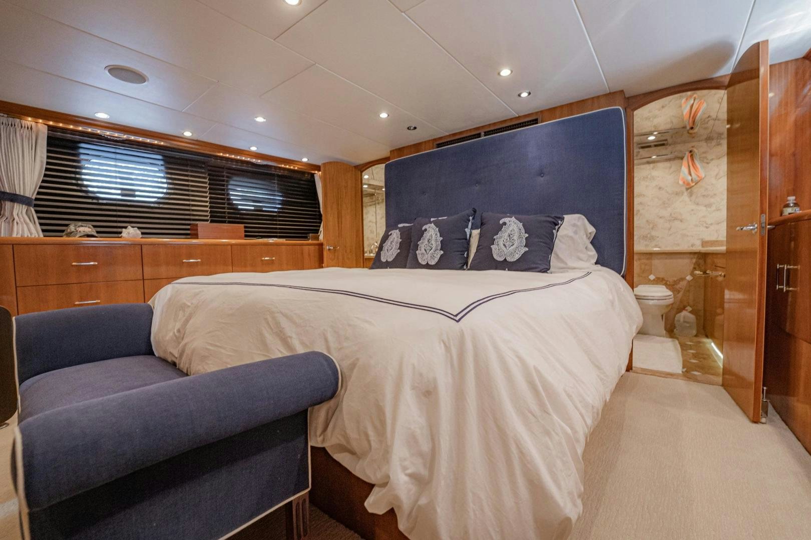 a bedroom with a bed and a couch aboard CRISTINA Yacht for Sale