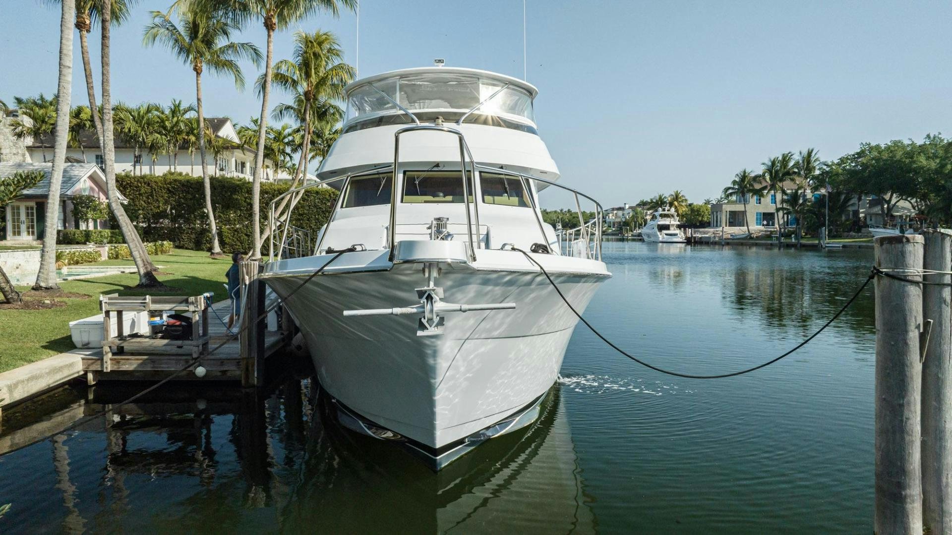 a white boat tied to a dock aboard CRISTINA Yacht for Sale