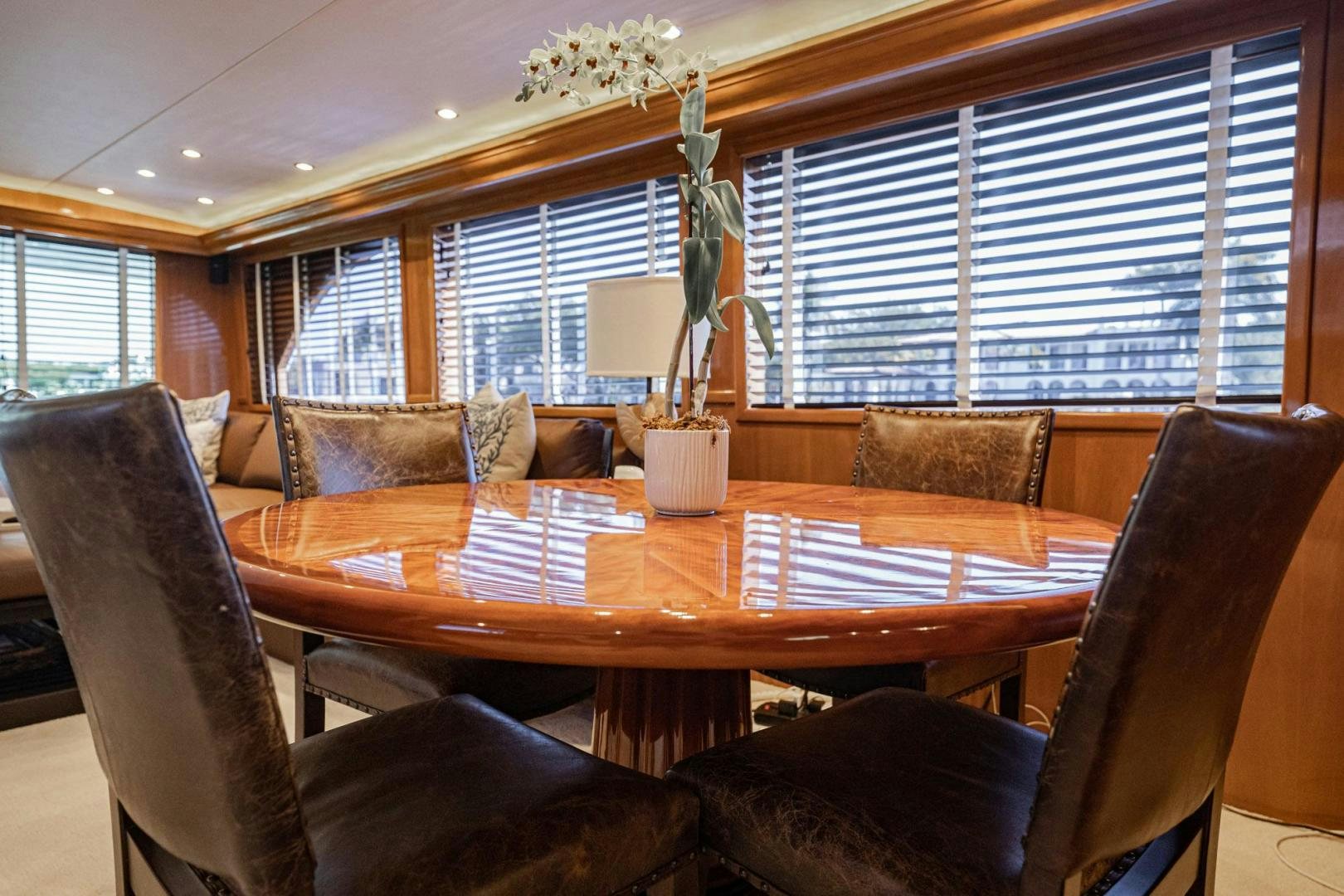 a living room with a table and chairs aboard CRISTINA Yacht for Sale