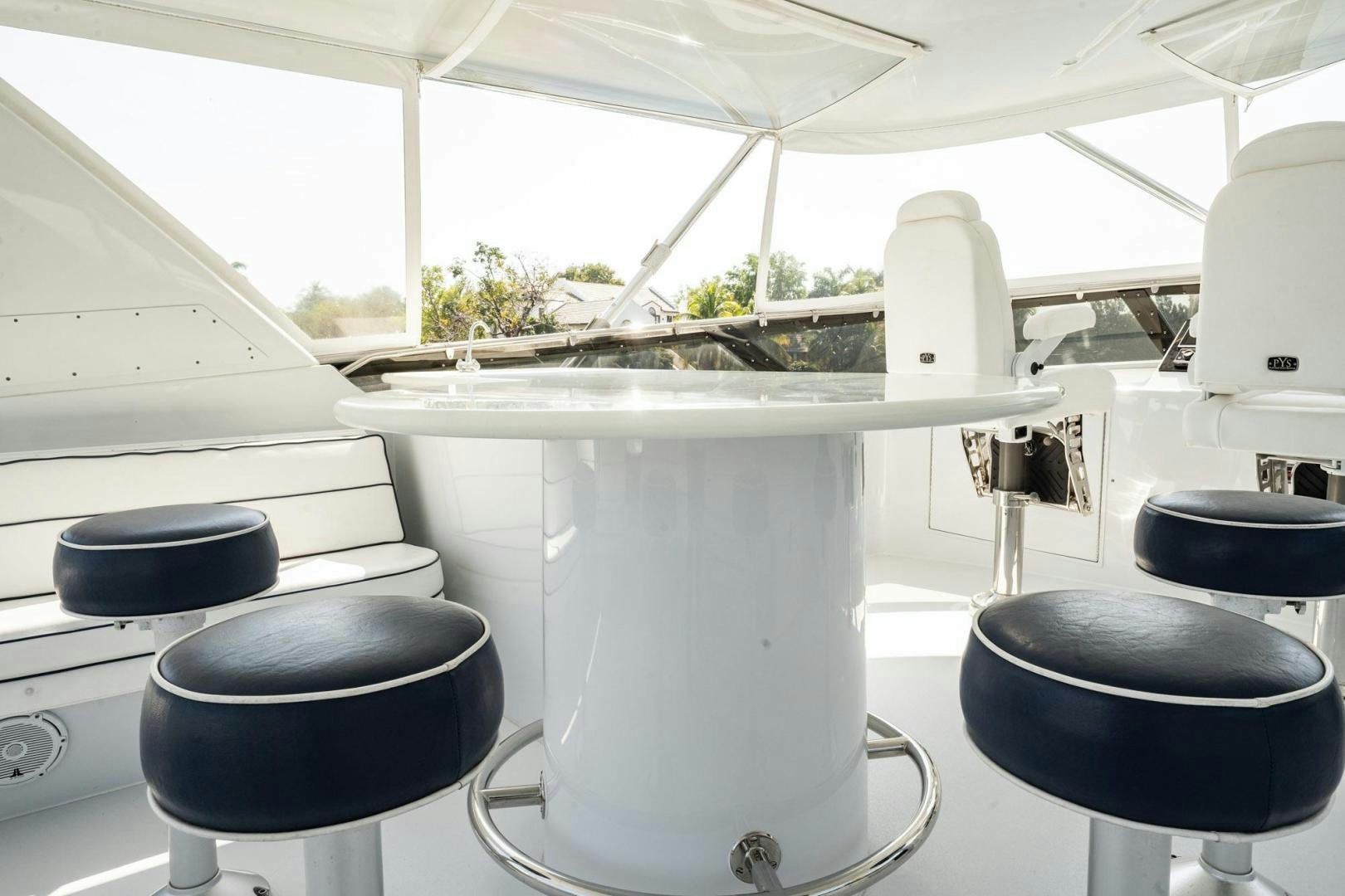 a white table with black chairs aboard CRISTINA Yacht for Sale