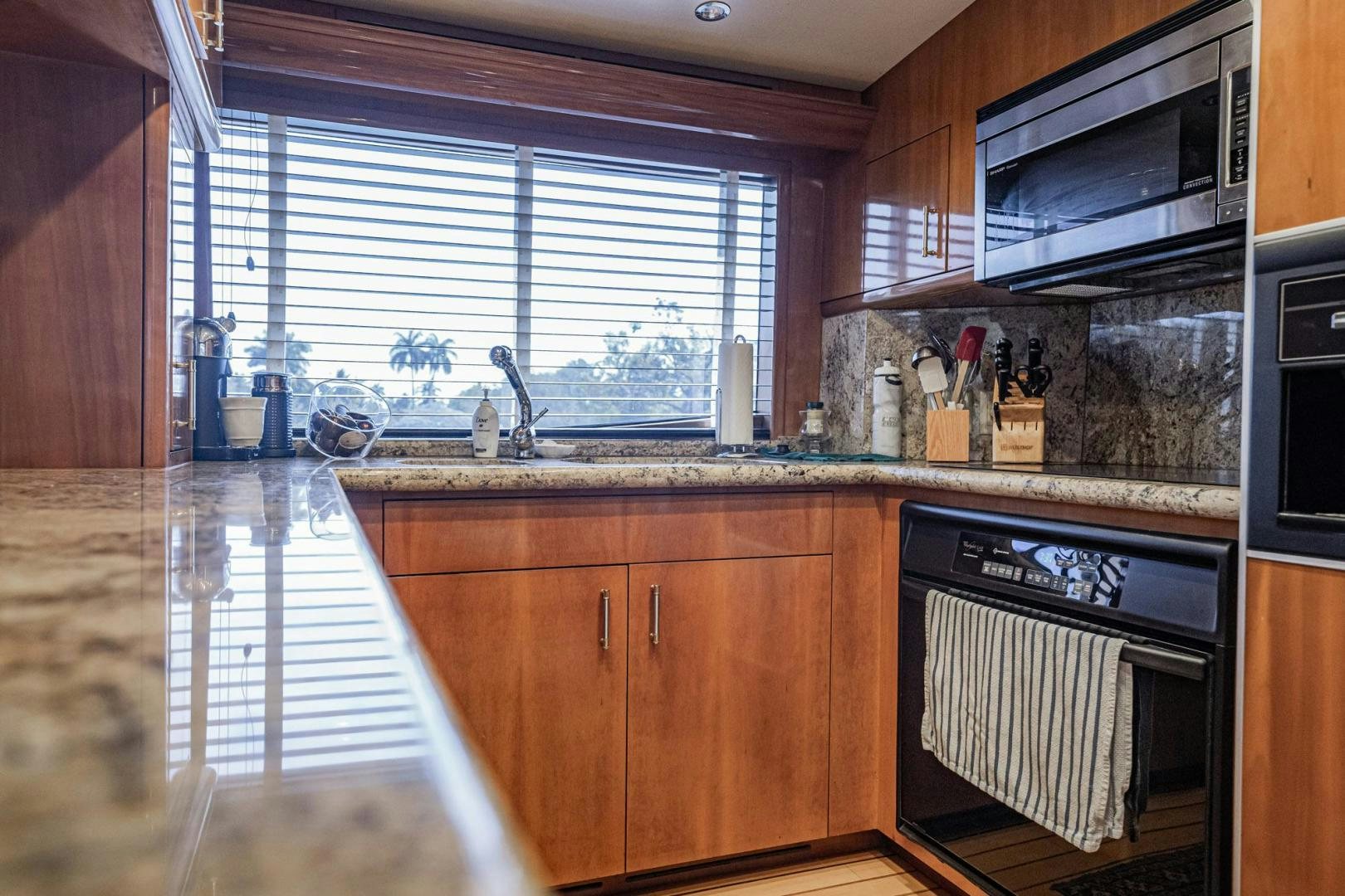 a kitchen with wooden cabinets aboard CRISTINA Yacht for Sale