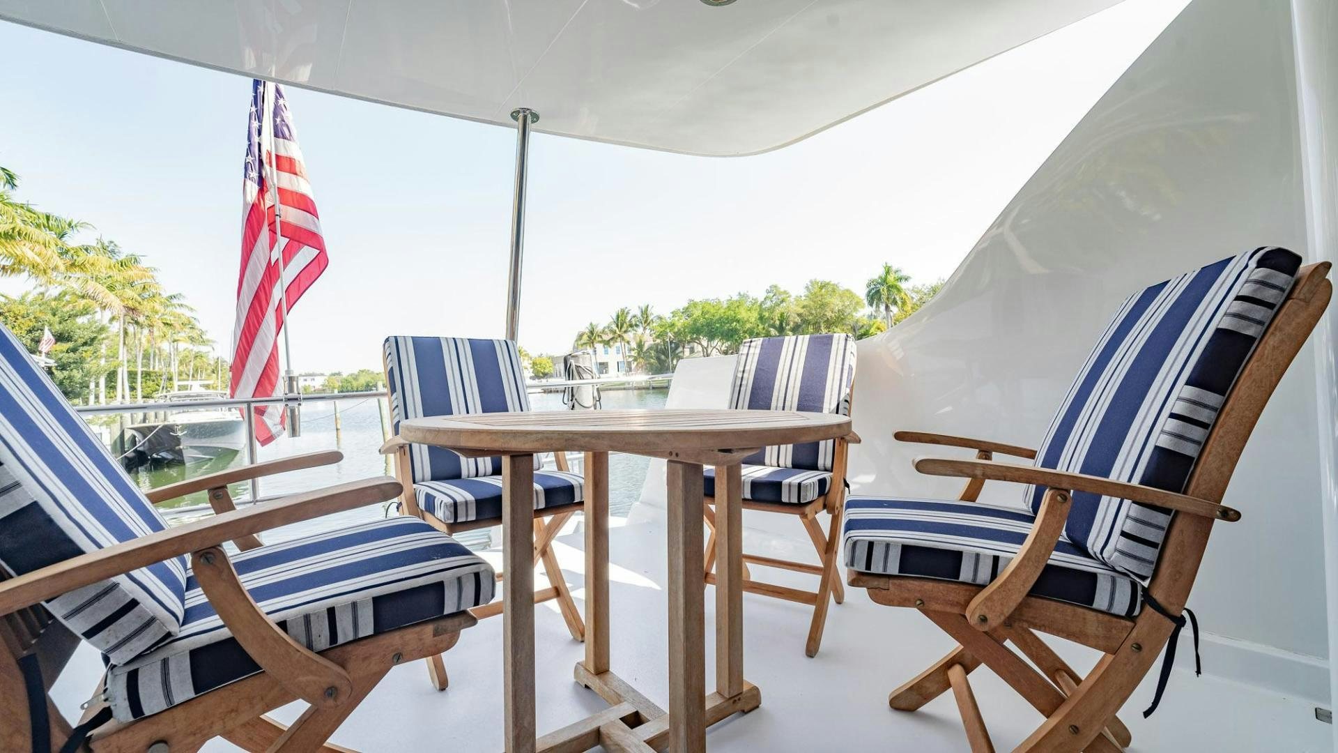 a table and chairs on a patio aboard CRISTINA Yacht for Sale
