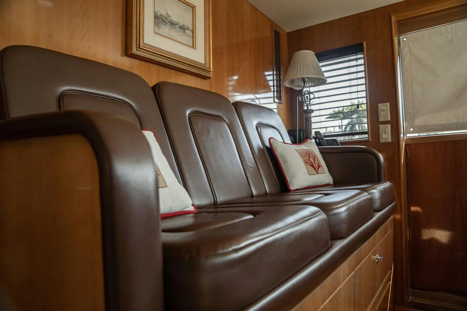 a leather couch in a room aboard CRISTINA Yacht for Sale