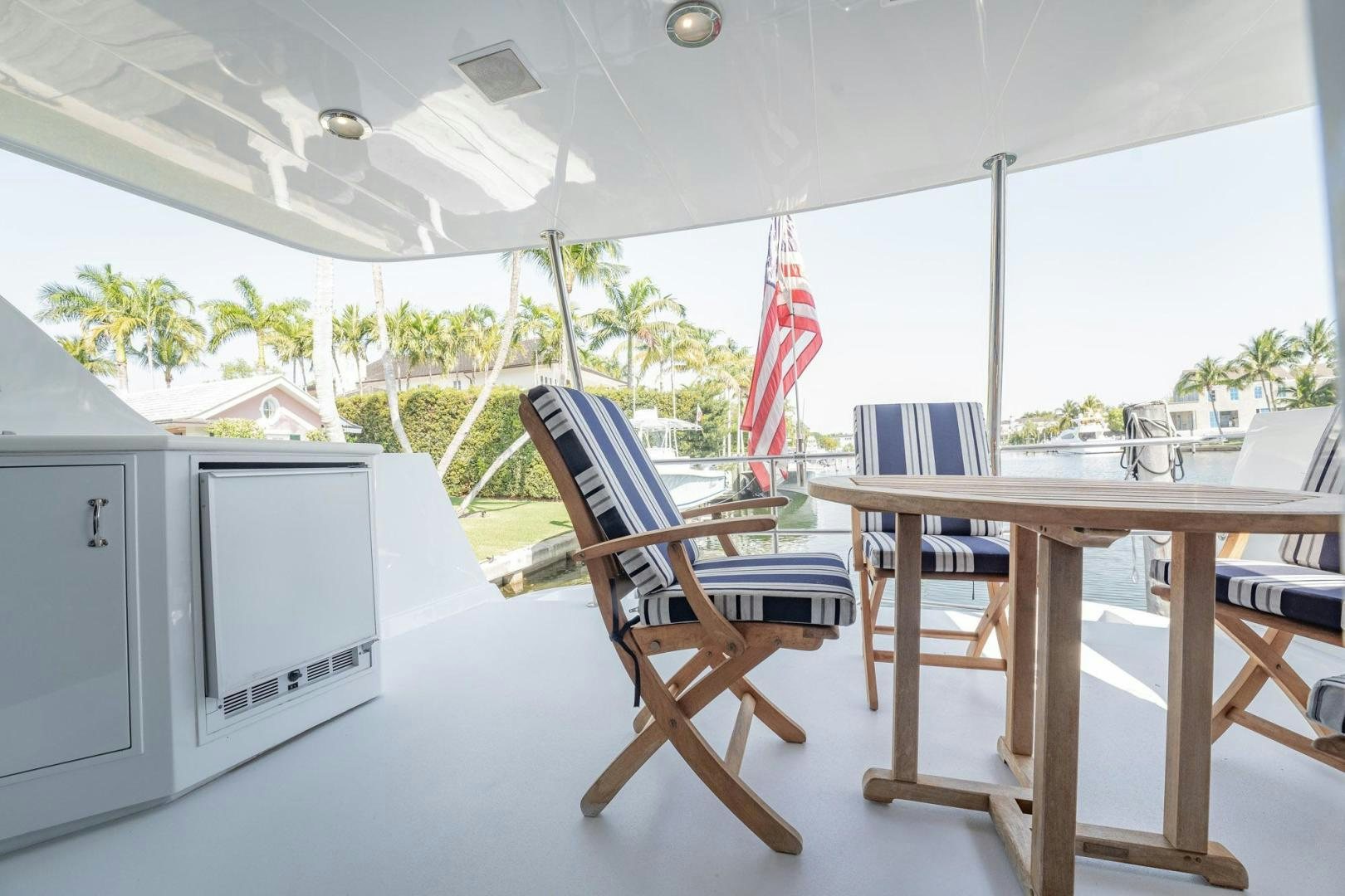 a chair and a table in a room with a window aboard CRISTINA Yacht for Sale