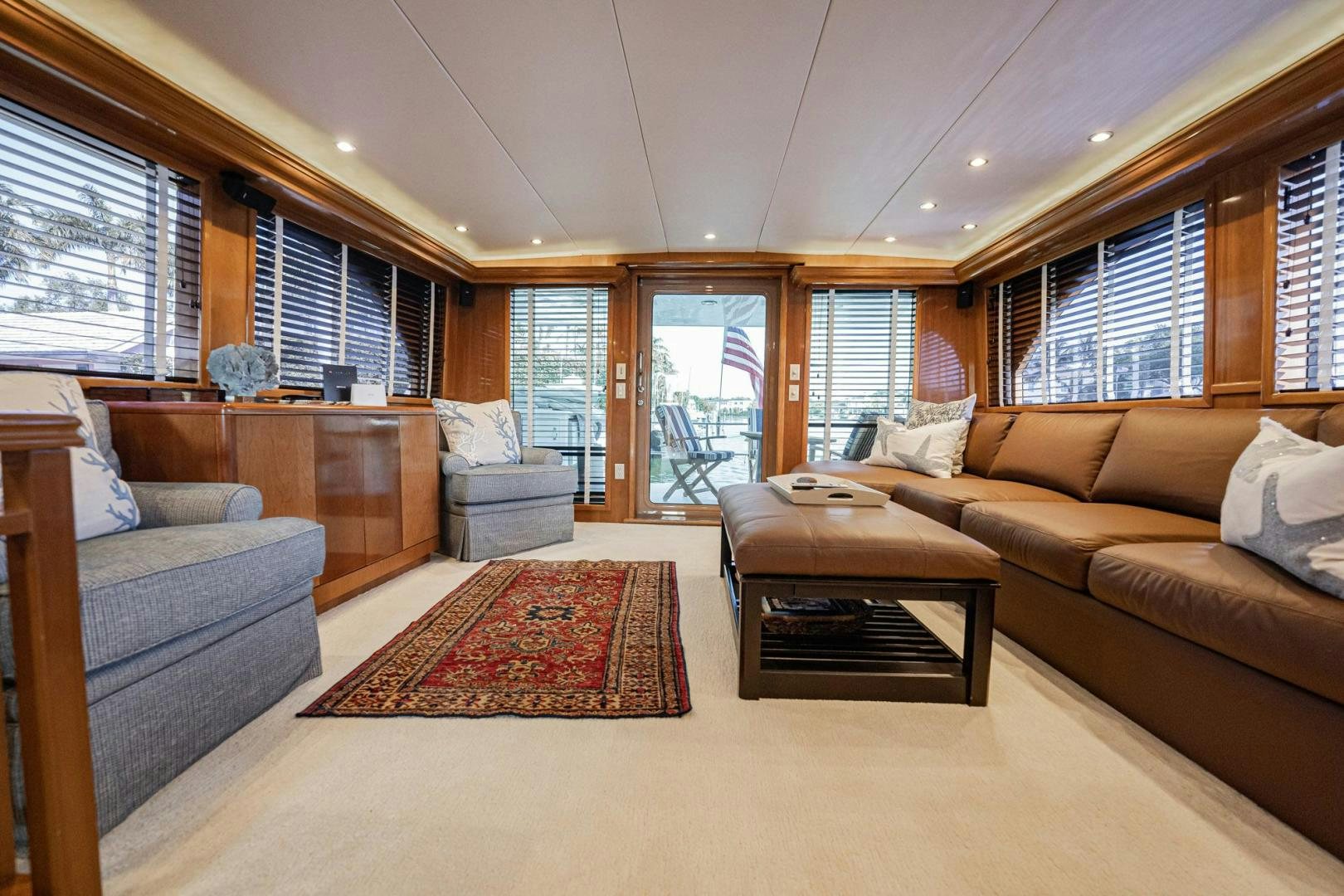 a living room with a couch and a coffee table aboard CRISTINA Yacht for Sale