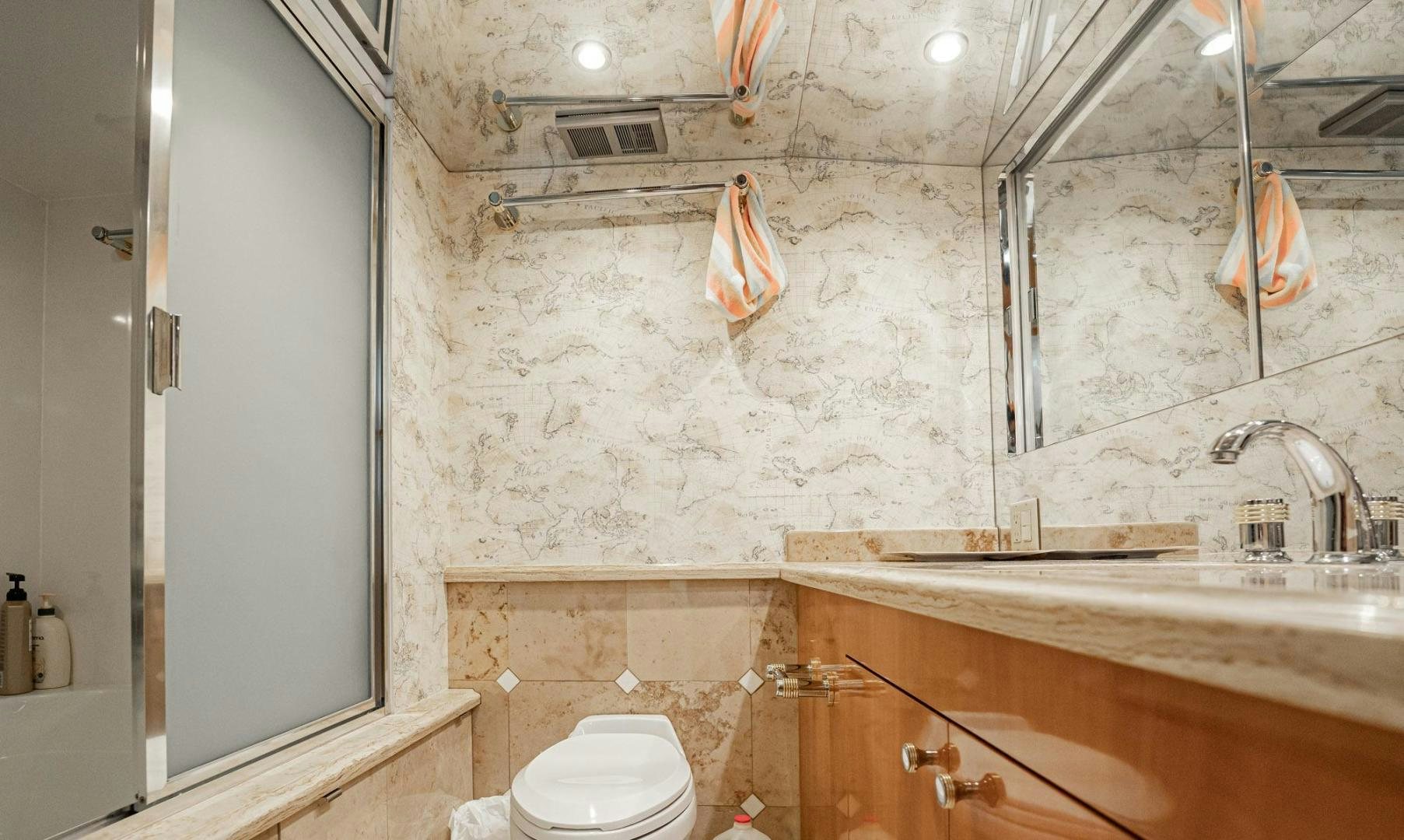 a bathroom with a toilet and sink aboard CRISTINA Yacht for Sale