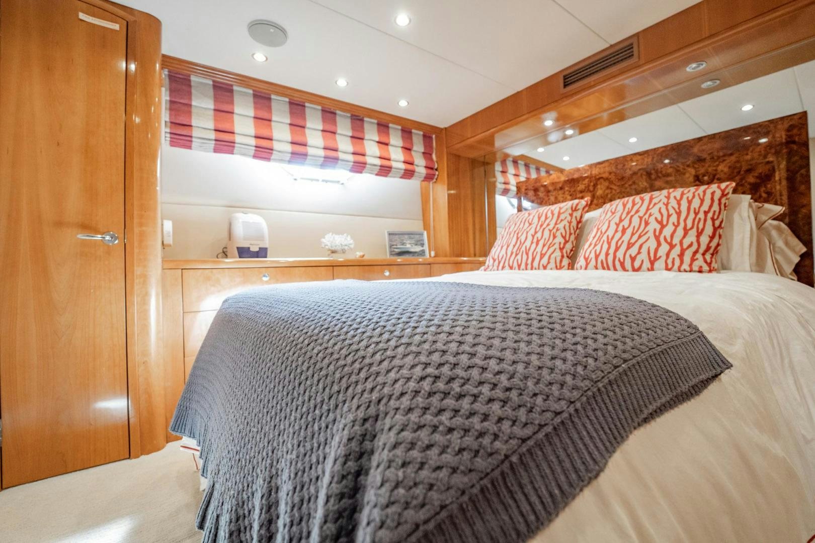 a bedroom with a bed and a desk aboard CRISTINA Yacht for Sale