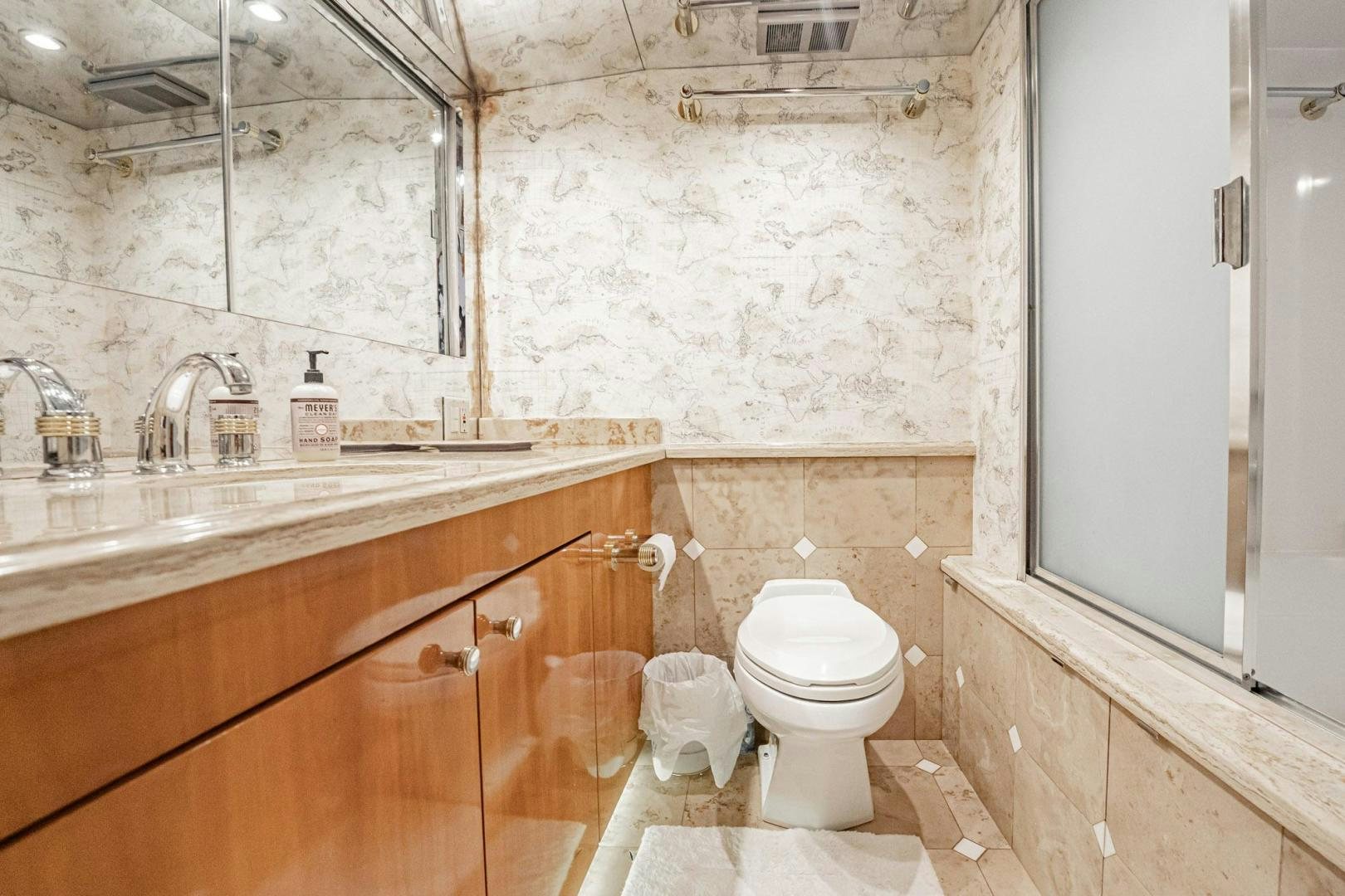 a bathroom with a toilet sink and a mirror aboard CRISTINA Yacht for Sale