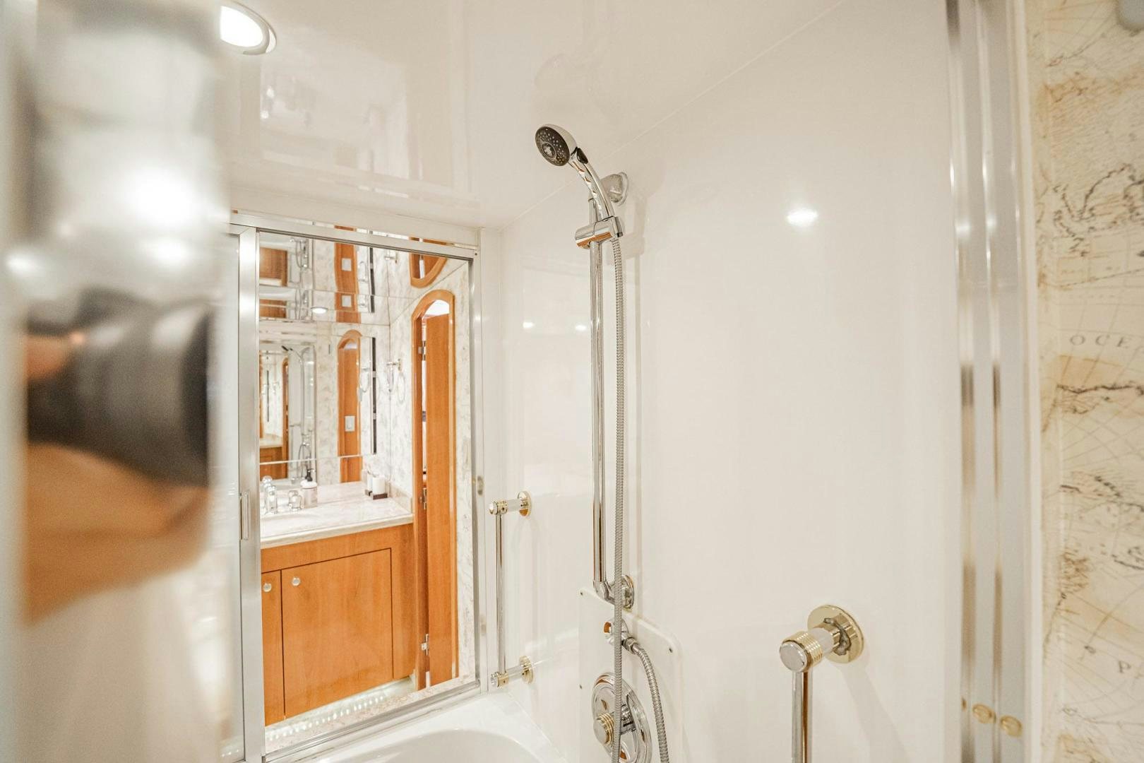 a bathroom with a mirror and a shower aboard CRISTINA Yacht for Sale
