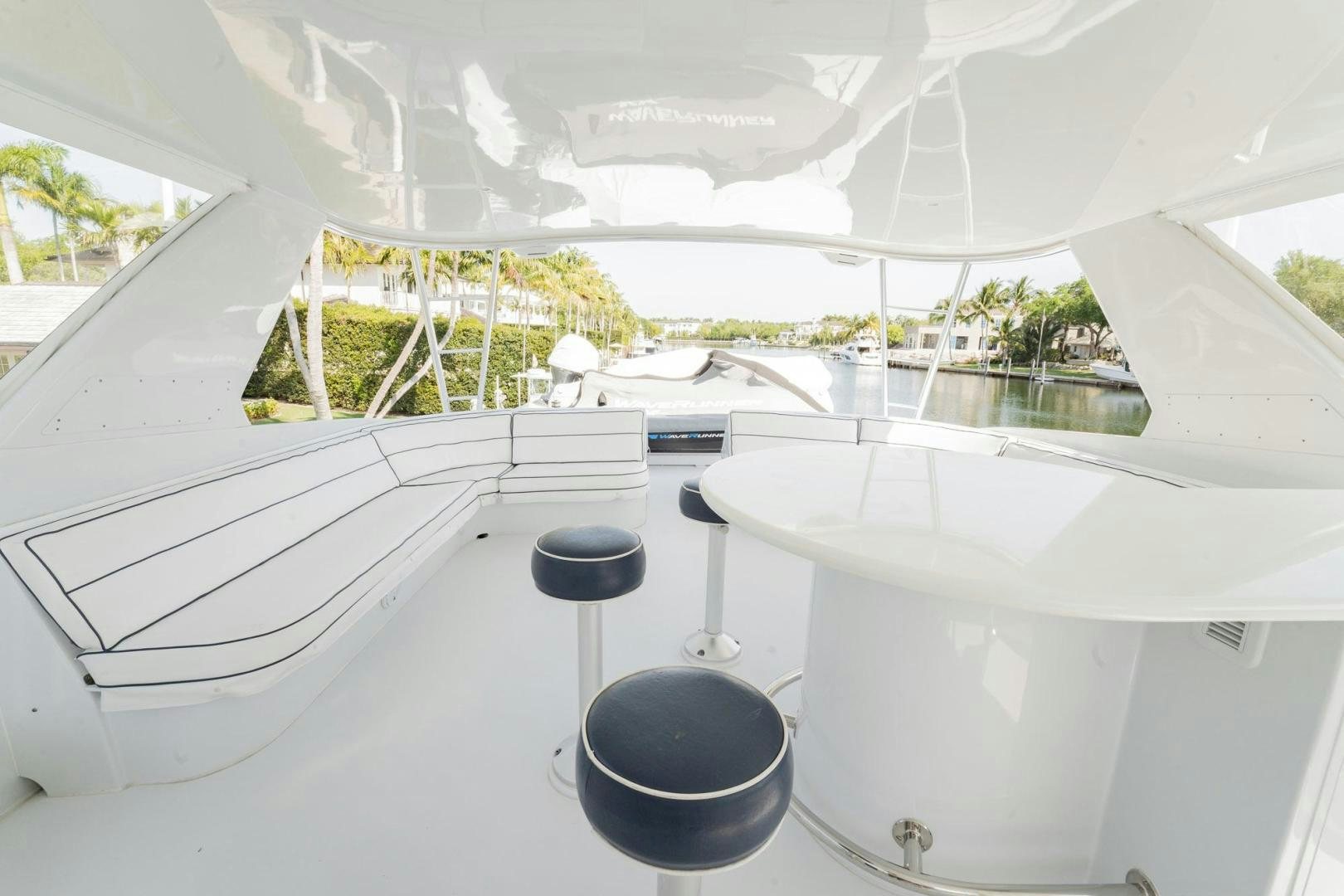 a white table with a black bucket on it and a black bucket on the side aboard CRISTINA Yacht for Sale