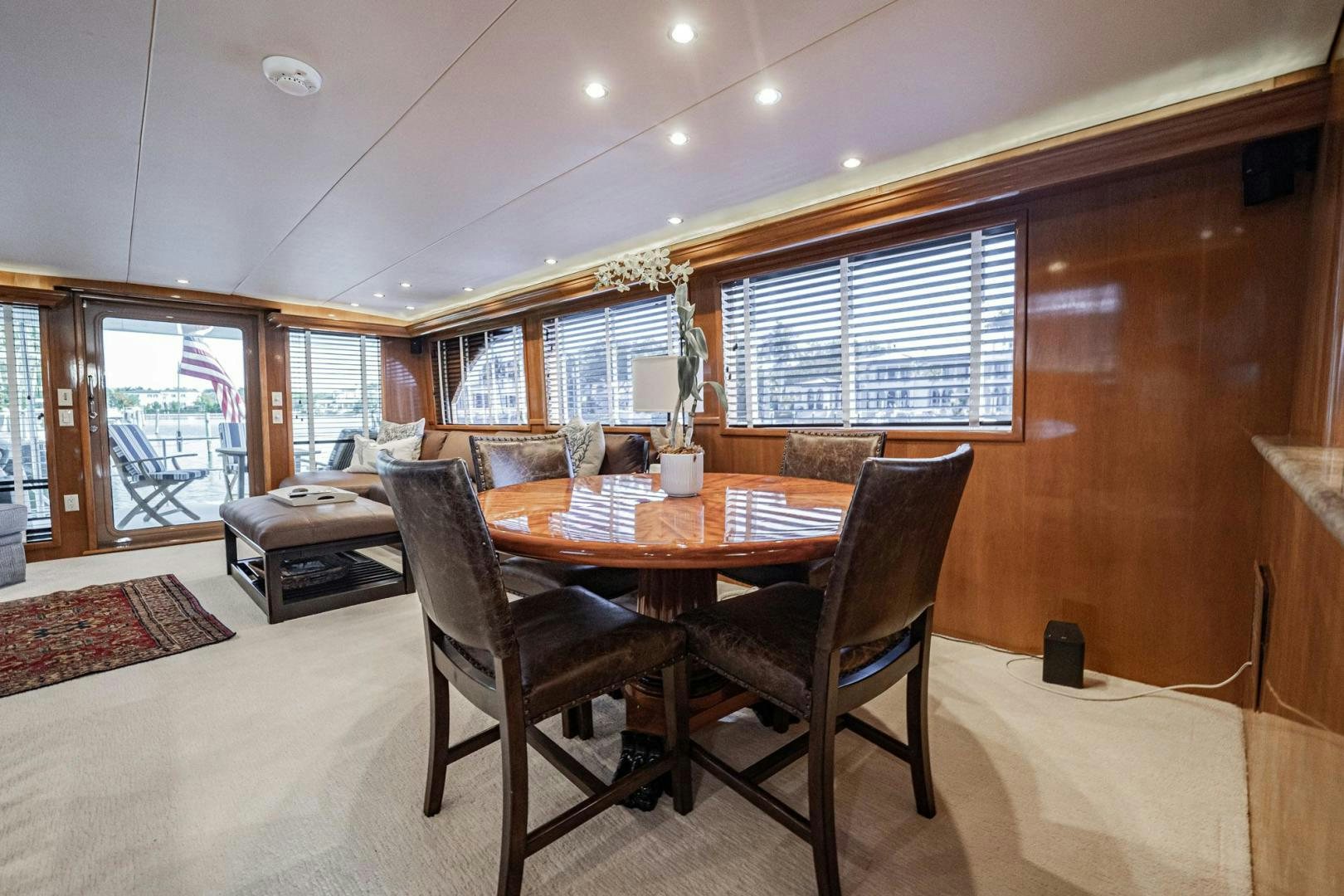 a dining table and chairs in a room with wood walls aboard CRISTINA Yacht for Sale
