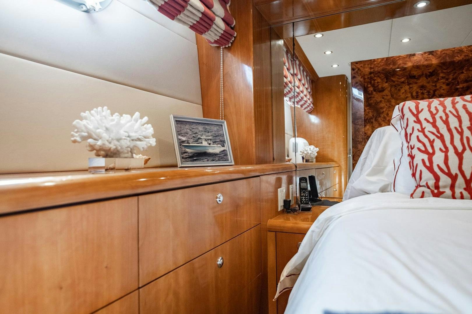 a bedroom with a dresser and a bed aboard CRISTINA Yacht for Sale