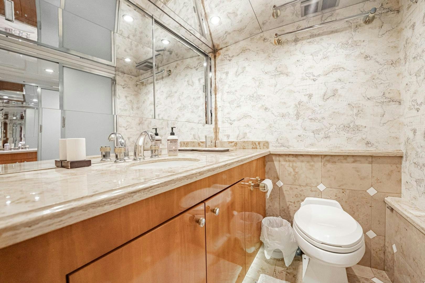 a bathroom with a toilet sink and a mirror aboard CRISTINA Yacht for Sale