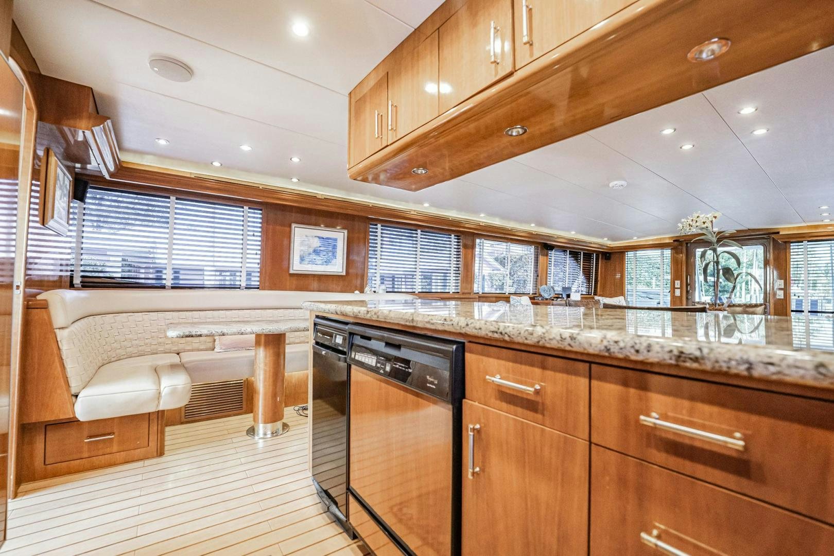 a kitchen with wooden cabinets aboard CRISTINA Yacht for Sale