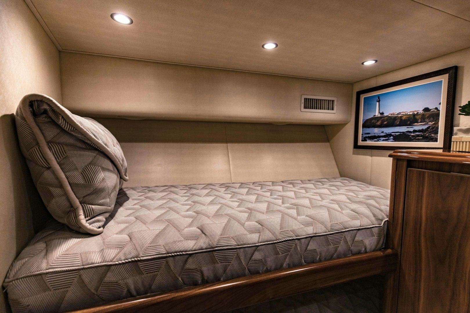 a bed with a television on the wall aboard SHOE Yacht for Sale