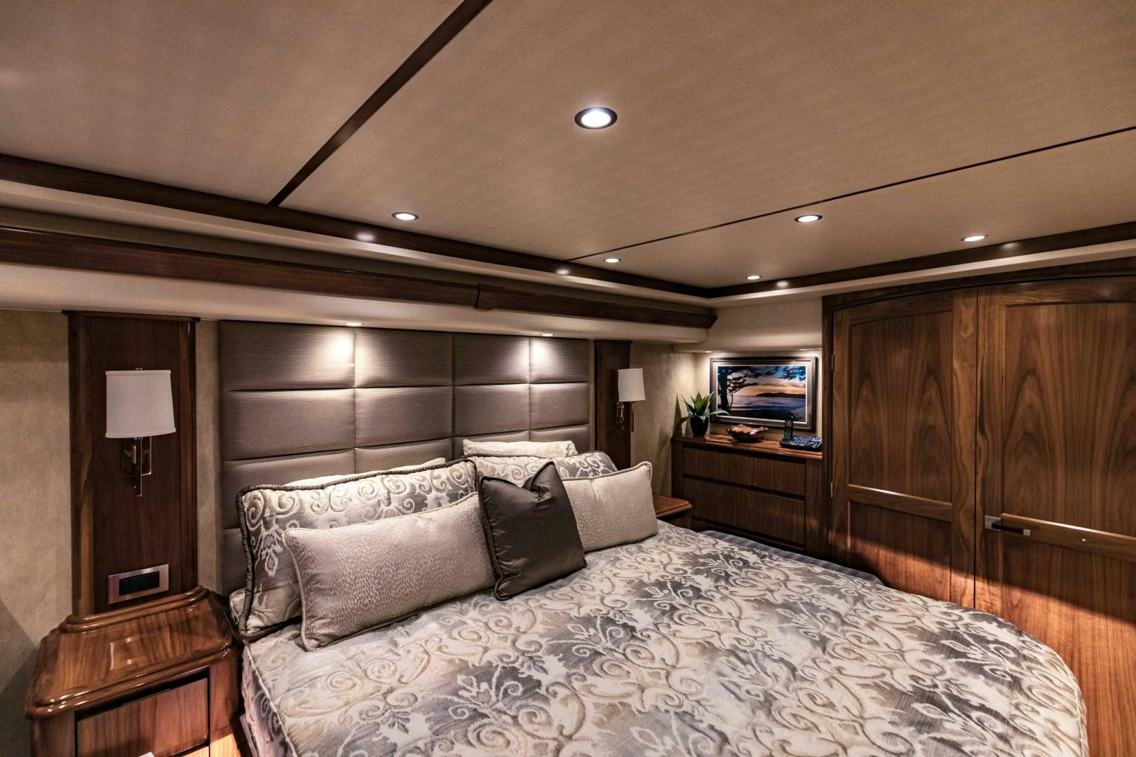 a bed with a white comforter aboard SHOE Yacht for Sale