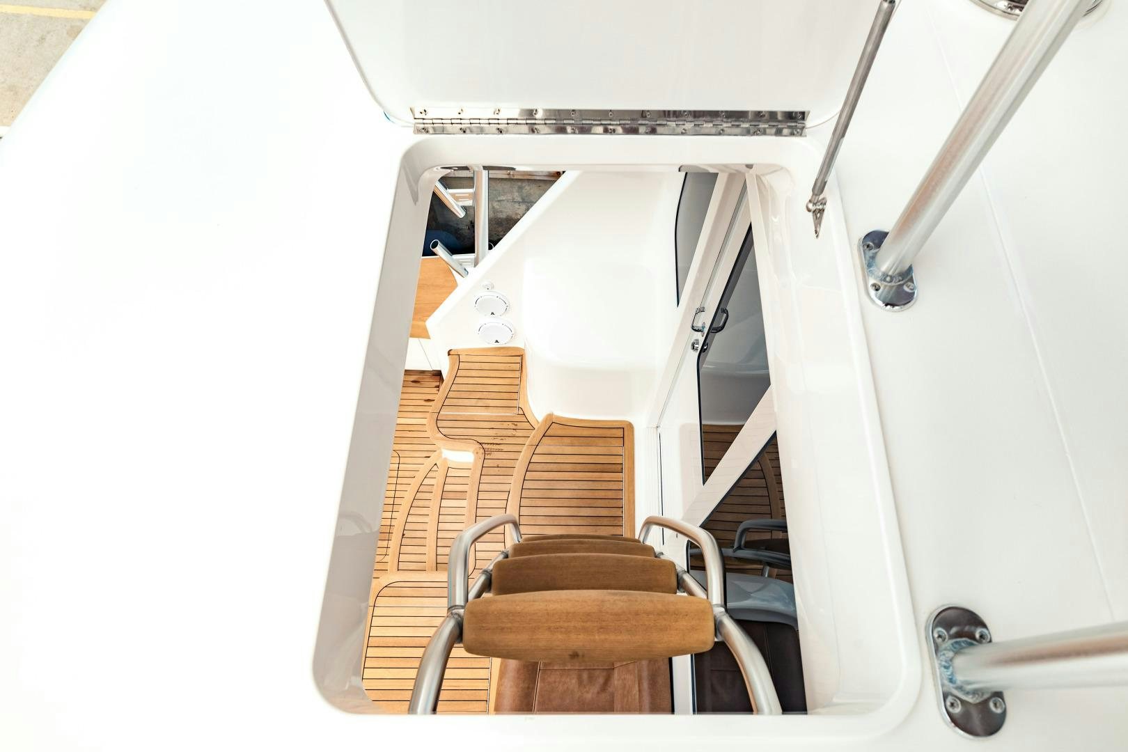 a white chair with a wood floor aboard SHOE Yacht for Sale