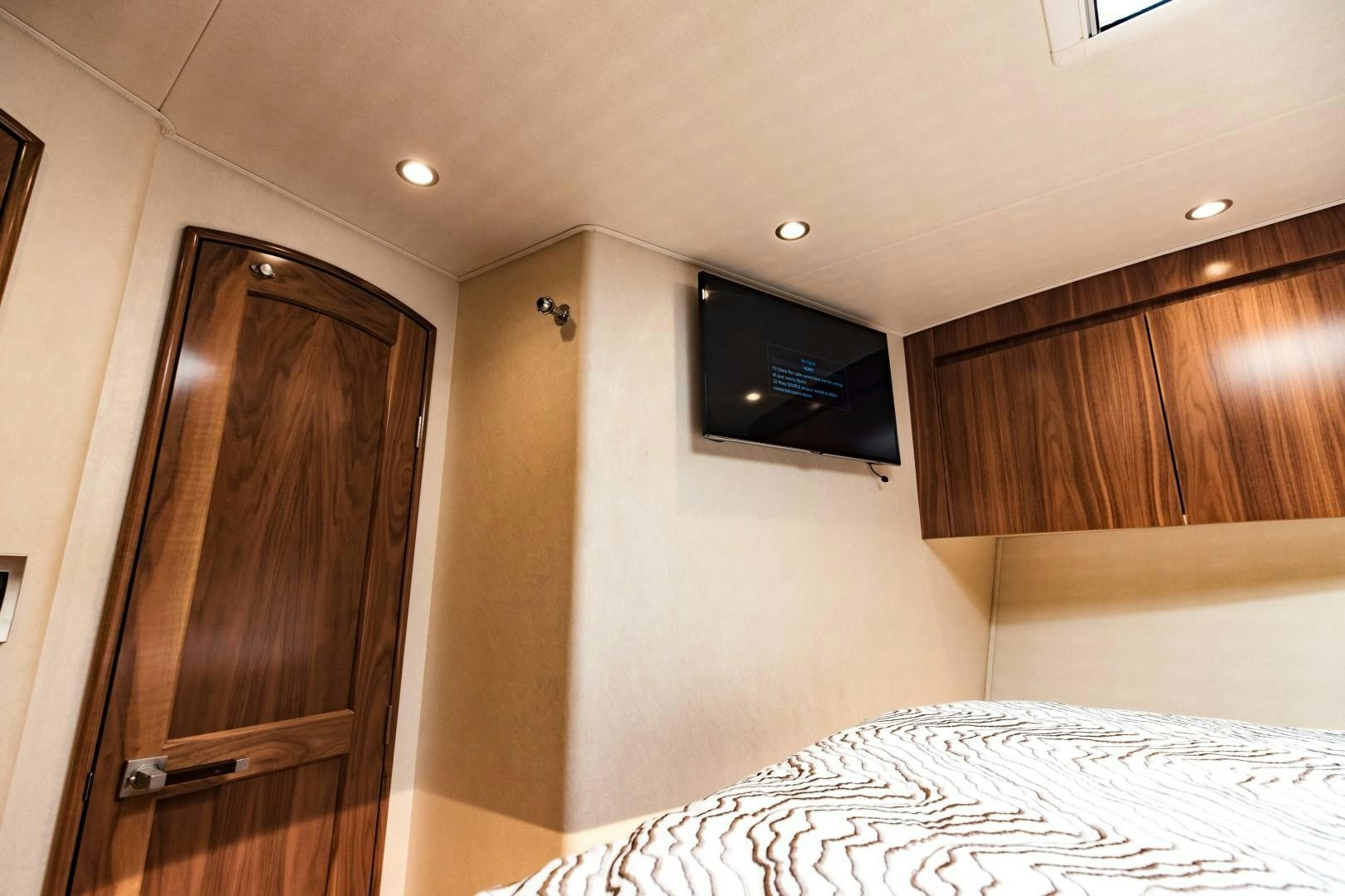 a bedroom with a tv on the wall aboard SHOE Yacht for Sale