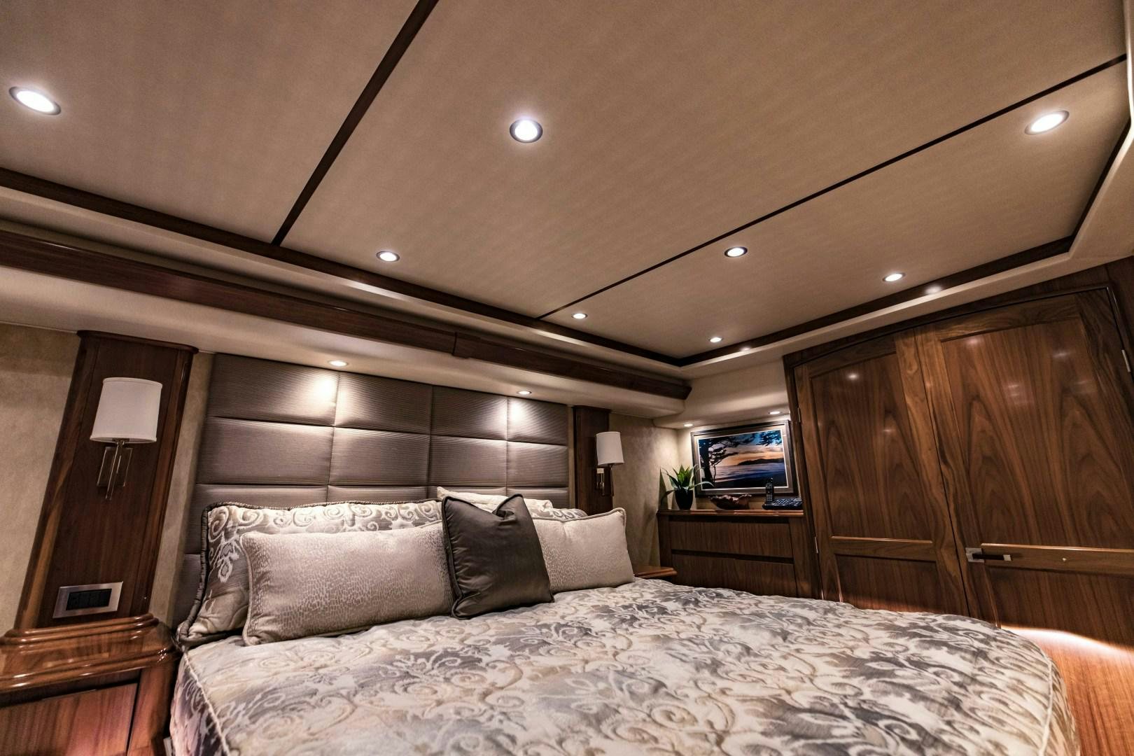 a bed with a white comforter aboard SHOE Yacht for Sale