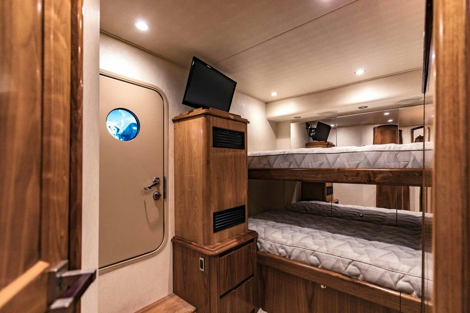 a room with a bed and a tv on the wall aboard SHOE Yacht for Sale