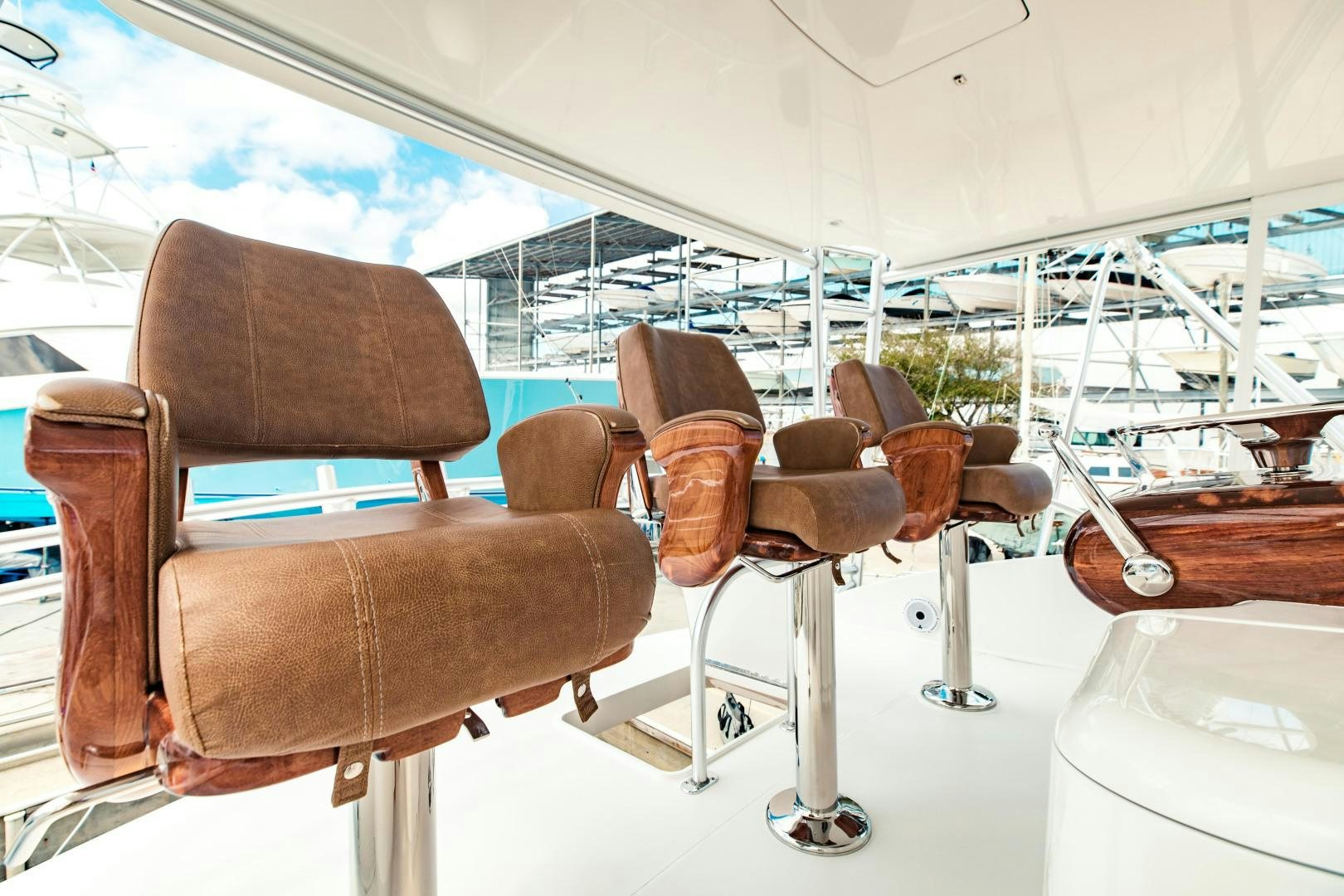 a group of brown chairs in a room with a large window aboard SHOE Yacht for Sale