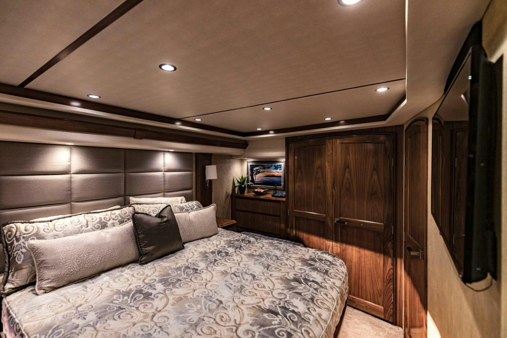 a bed with a wooden headboard aboard SHOE Yacht for Sale