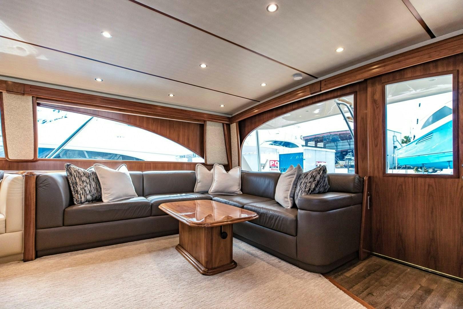 a living room with a couch and a coffee table aboard SHOE Yacht for Sale