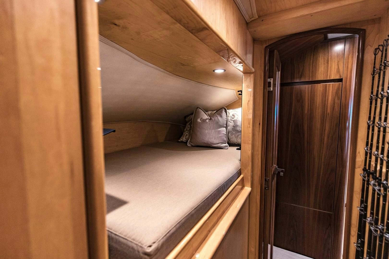 a bedroom with a bed and a closet aboard SHOE Yacht for Sale
