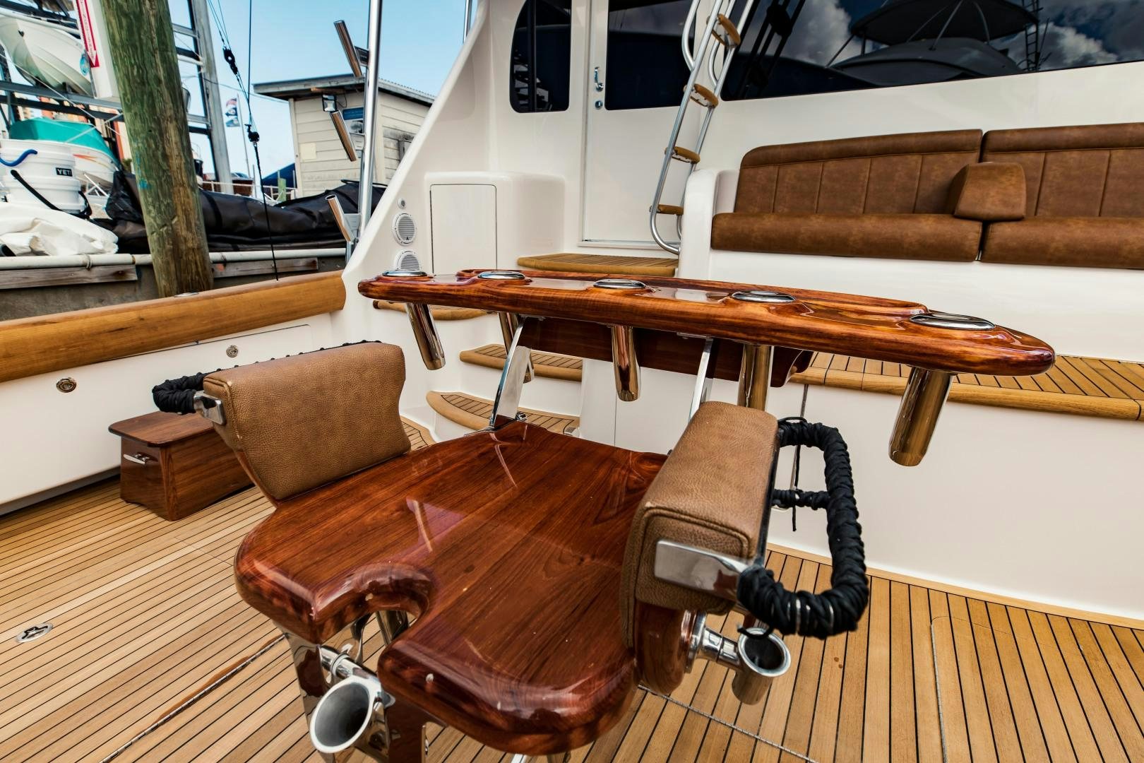 a wooden table and chairs on a deck aboard SHOE Yacht for Sale