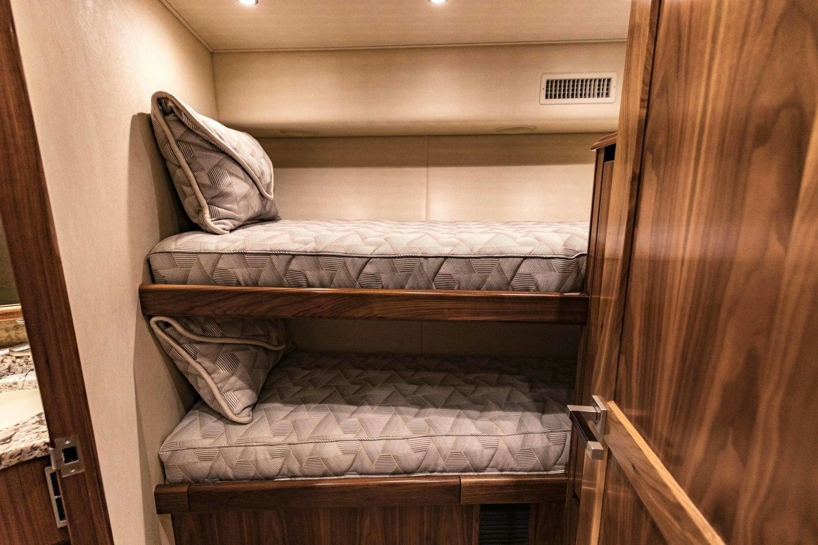 a bed with a wooden frame aboard SHOE Yacht for Sale